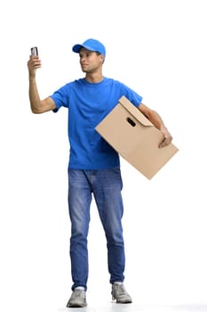 Male deliveryman, on a white background, full-length, with a phone and box.