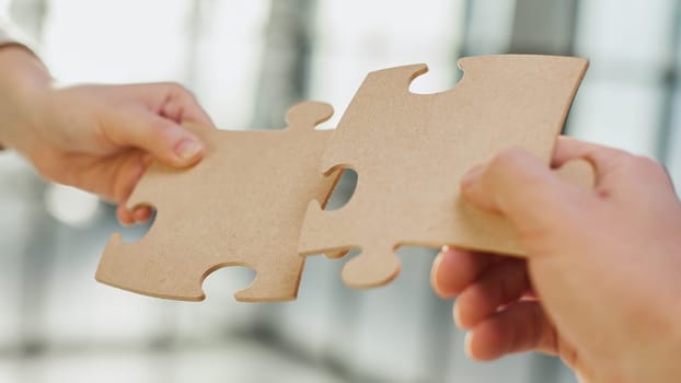 close up of business people connecting couple puzzle jigsaw