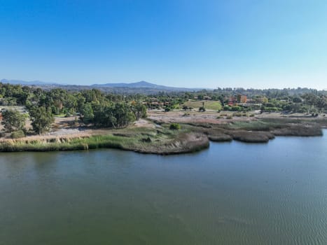 Aerial view over water reservoir and a large dam that holds water. Rancho Santa Fe in San Diego, California, USA