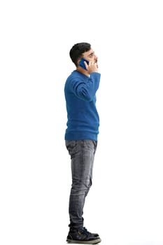 A man, full-length, on a white background, talking on the phone.