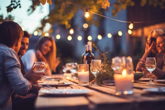 Happy friends having fun outdoor. Group of friends having backyard dinner party together.