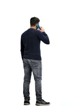 A man, full-length, on a white background, talking on the phone.