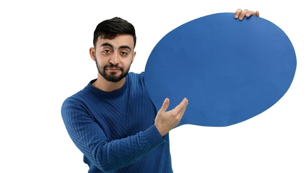 A man, close-up, on a white background, shows a blue comment sign.