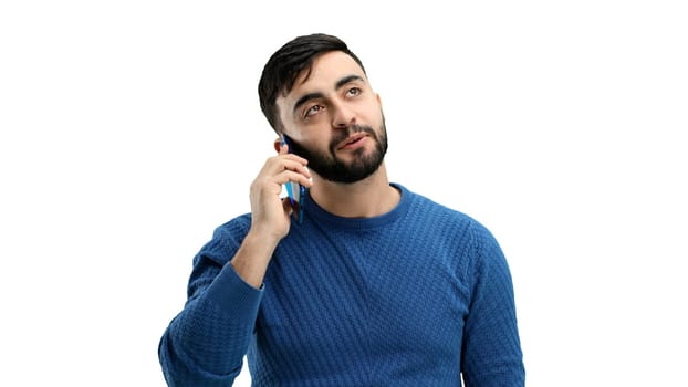 Man, close-up, on a white background, talking on the phone.