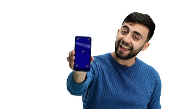 A man, close-up, on a white background, shows a phone.