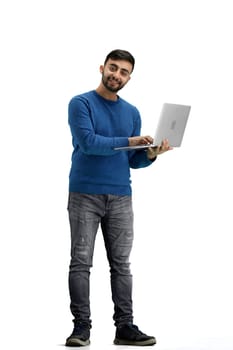 A man, full-length, on a white background, uses a laptop.
