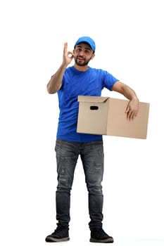 The deliveryman, in full height, on a white background, shows the ok sign.