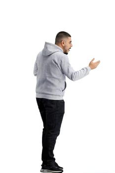 A man, full-length, on a white background, spreads his arms.