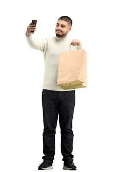 A man, full-length, on a white background, with bags.