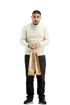 A man, full-length, on a white background, with bags.