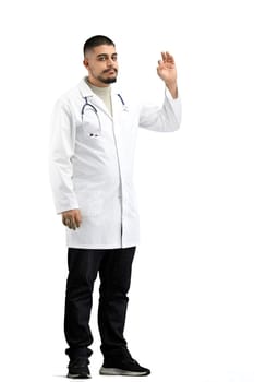 The doctor, in full height, on a white background, shows the ok sign.