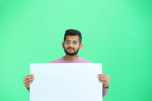 Man, on a green background, close-up, with a white sheet.