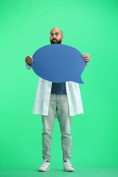 Male doctor, on a green background, full-length, with a blue comment mark.