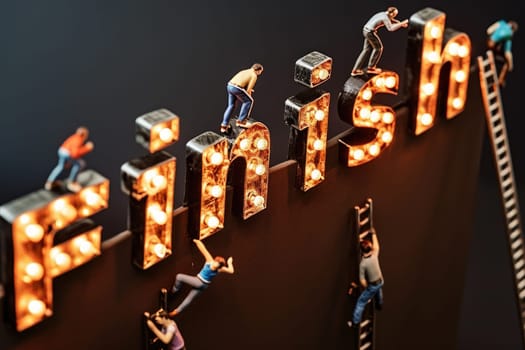 Figurine of many people action to lean on the ladder and climb up to the top a giant word Finish.