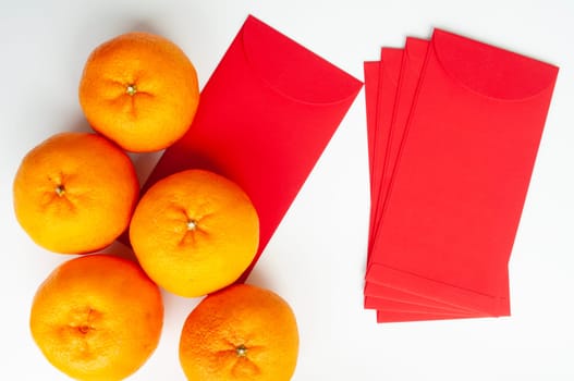 Top view of Mandarin oranges and Chinese New Year red envelope. Chinese New Year celebration concept.