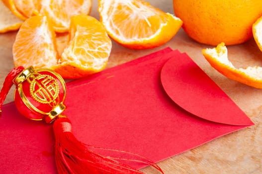 Peal Mandarin oranges and Chinese New Year red packet. Chinese New Year celebration concept.