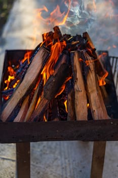 Burning wood chips to form coal. Barbecue preparation, fire before cooking.