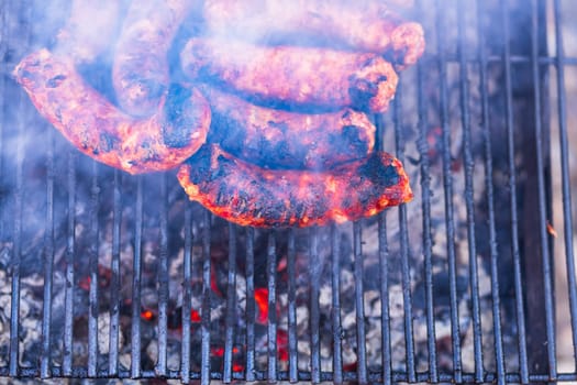 Sausages grilled on a charcoal barbeque. Top view of tasty barbecue, food concept, food on grill and detail of sausages on the grill