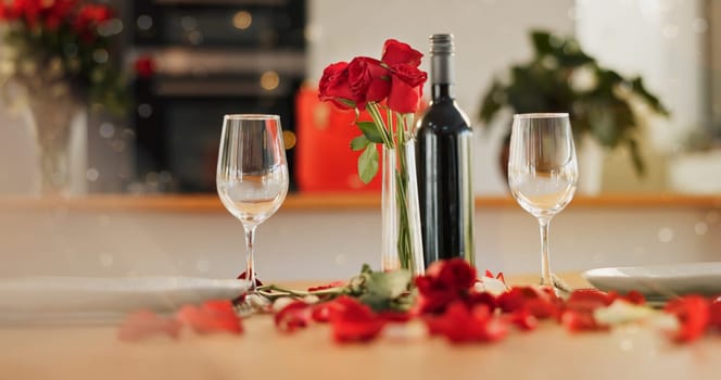 Wine, glass and romance on valentines day for celebration of love, anniversary or honeymoon in still life. Flowers, dinner and elegant date in dining room of home for event, milestone or occasion.