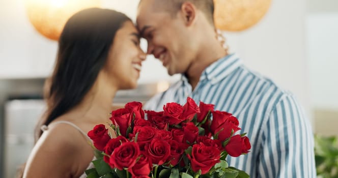Couple, flowers and kiss for anniversary celebration, marriage and loyalty or commitment to love. People, happy and romance for relationship milestone, bonding and plant gift for support at home.