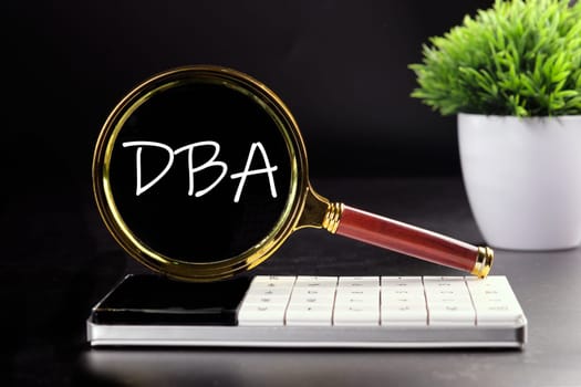DBA text seen with a magnifying glass on a black background