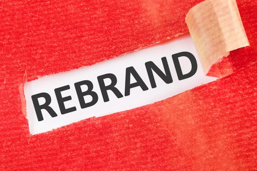 REBRAND the inscription under the torn paper on a white background