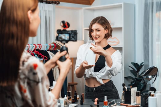 Woman influencer shoot live streaming vlog video review makeup utmost social media or blog. Happy young girl with cosmetics studio lighting for marketing recording session broadcasting online.