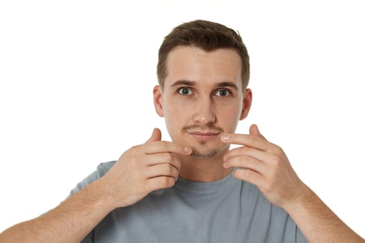 surprised guy looking at camera on white studio background