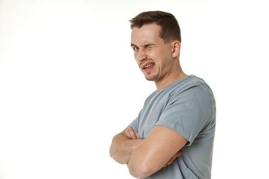 portrait of young happy man winking looking at the camera on white background