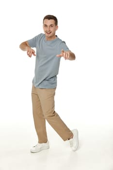 happy guy looking pointing at the camera on white studio background