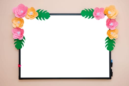 School board for drawing with markers. The drawing board is decorated with artificial flowers.