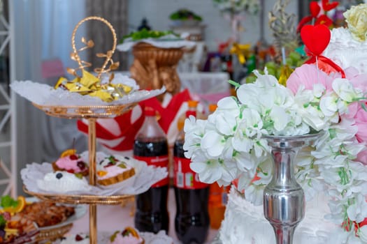 The festive table is decorated with white flowers. Ukraine, Vinnytsia, August 10, 2021