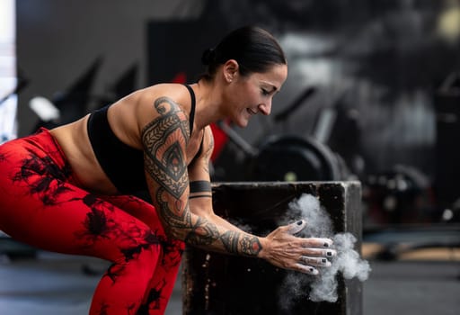 Magnesium dust floating from the hands of a sporty woman about to lift weights