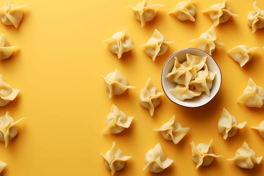 Multiple dumplings organized around a bowl on a yellow background