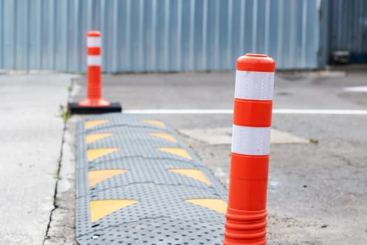 Orange restrictive poles on the road close up