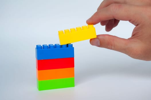 Plastic building-block toys on white cover background. Childhood toy concept.