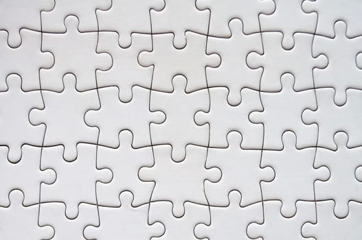 Top view of white jigsaw puzzle. Gaming concept.