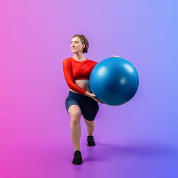 Full body length gaiety shot athletic and sporty young woman with fitness exercising ball in standing posture on isolated background. Healthy active and body care lifestyle.