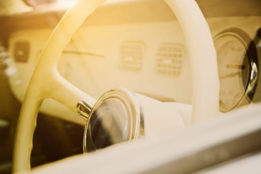 Steering wheel and dashboard of a classic car. Vintage style.