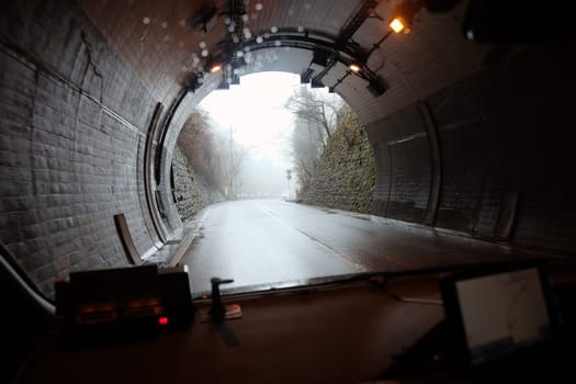 Underground tunnel with cars in the evening. Blurred background.