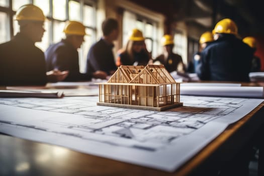 House models sit on top of several different architects drawings and floor plan.