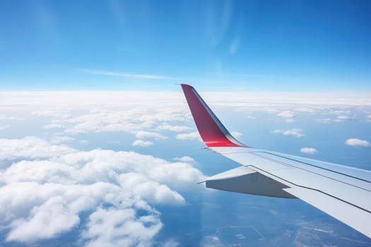 Photo View from the window of an airplane wing while flying over a blue sky.