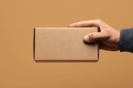 a hand holding a mailing box mockup delivery service concept photo.