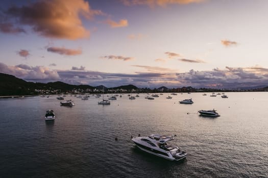 Many moored yachts off the coast at sunset. High quality photo