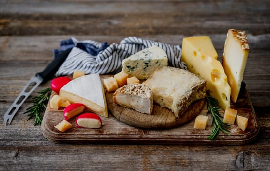 Handmade Cheese Set On Old Wooden Table With Cheese Knife