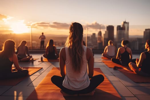 Group yoga class on the roof of a building in the sun.