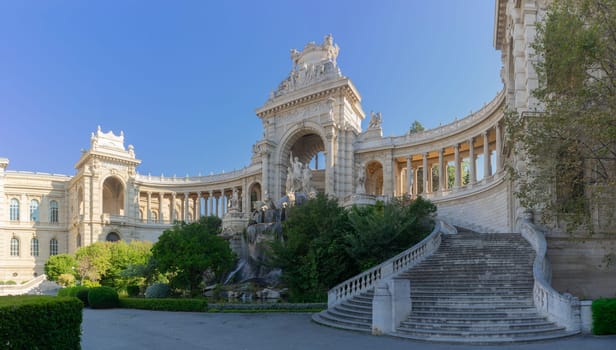 The Palais Longchamp in Marseille stands in majestic splendor, its intricate stone arches and grand staircase basking in the soft light of day. Statues and fountains adorn this monument of history, nestled within a lush park, exuding the elegance of 19th-century French architecture