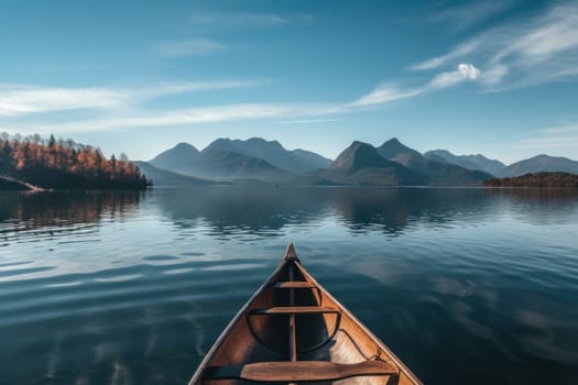 Canoe in the middle of the lake, mountains and clear sky background.