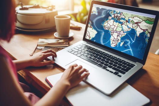 Tourist planning vacation use laptop for search and check hotel and travel accessories on table.