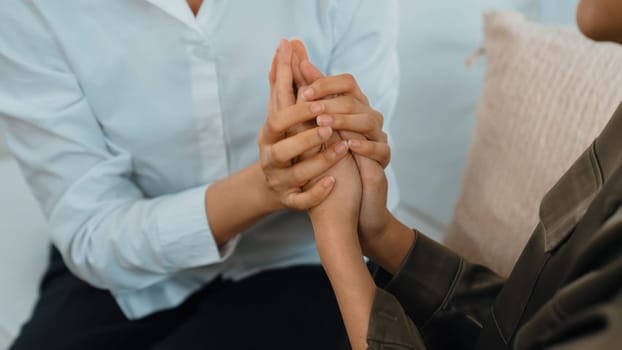 Supportive and comforting hands cheering up depressed patient person or stressed mind with empathy. Psychologist reassuring stressful and sad patient in vivancy clinic.